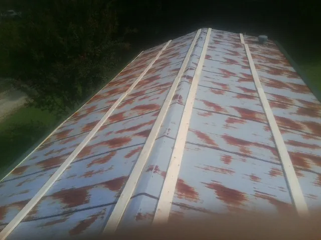 Rusted metal roof panels with new wood purlins before replacement — Storm Damage Roof Repair in Pacific by Roofing Brothers
